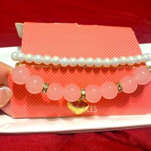 Pink with a gold heart and white bracelet